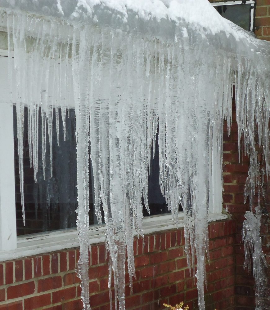Large icicles hanging from the eave of a building